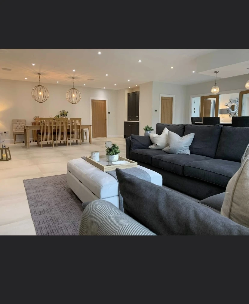 Light tiled floor continuing through an open-plan living and dining area
